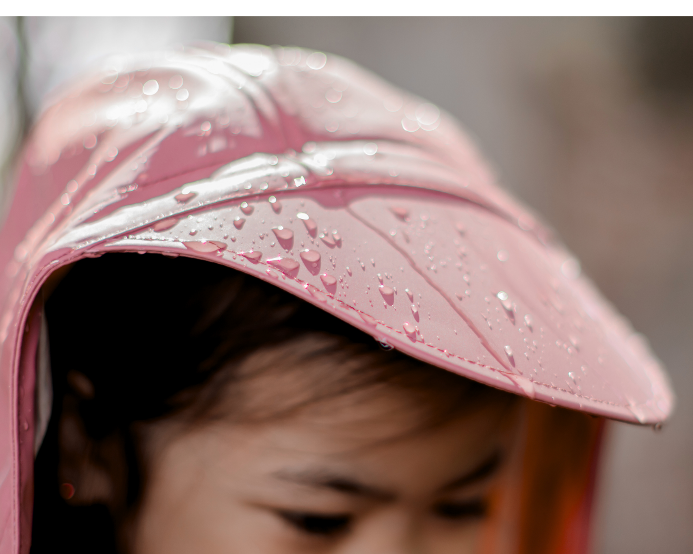 Waterproof kids rain jacket hood with brim and mud guard, rain droplets on durable fabric